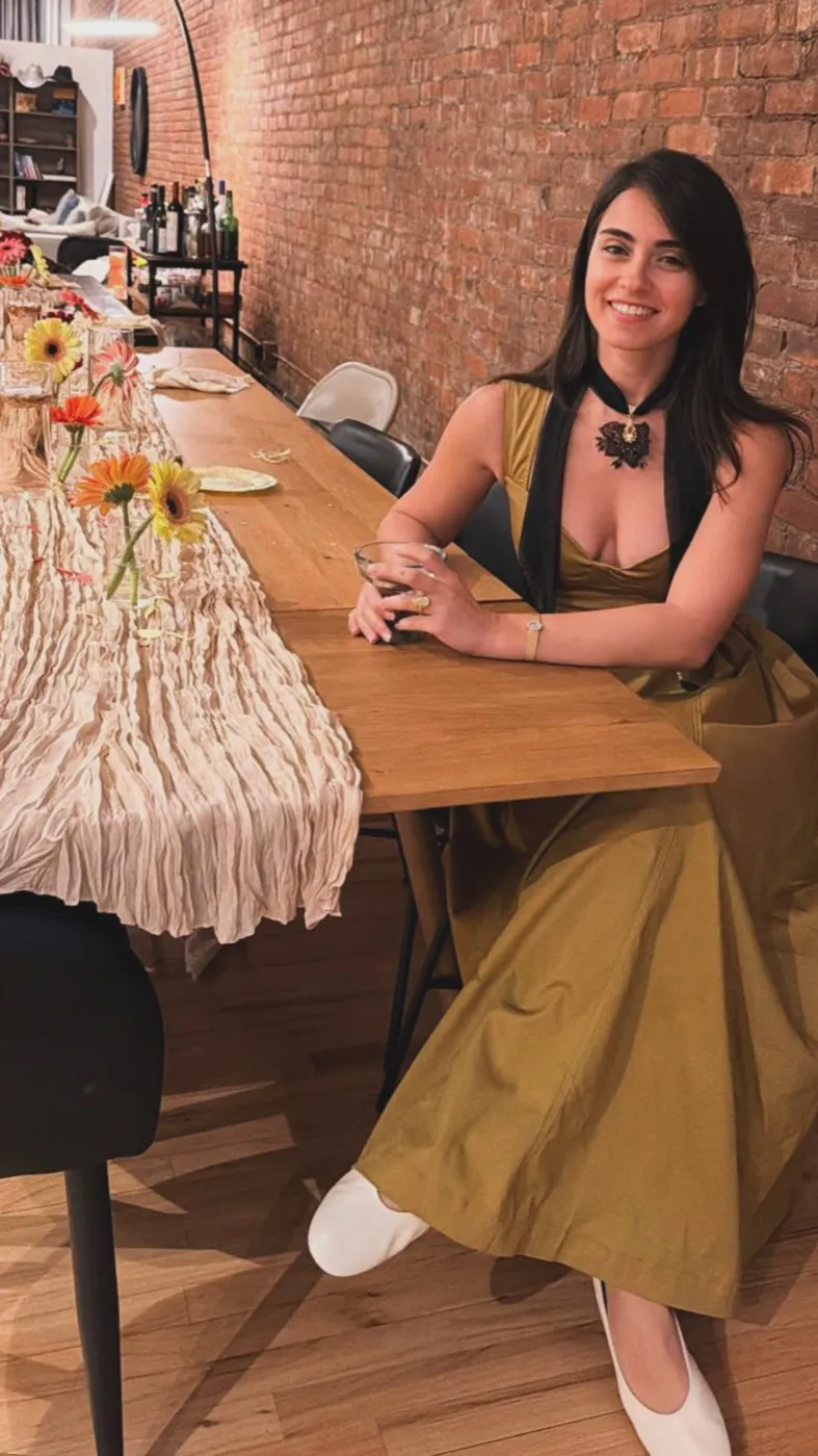 Meltem Cakmak Shuman at the long dining table where dear me collective began